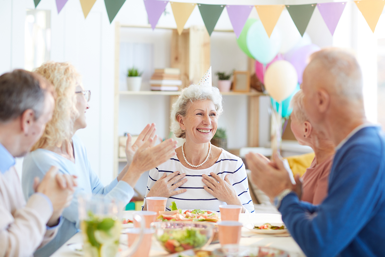 group of people talking at a social gathering where background noise makes conversations harder to follow