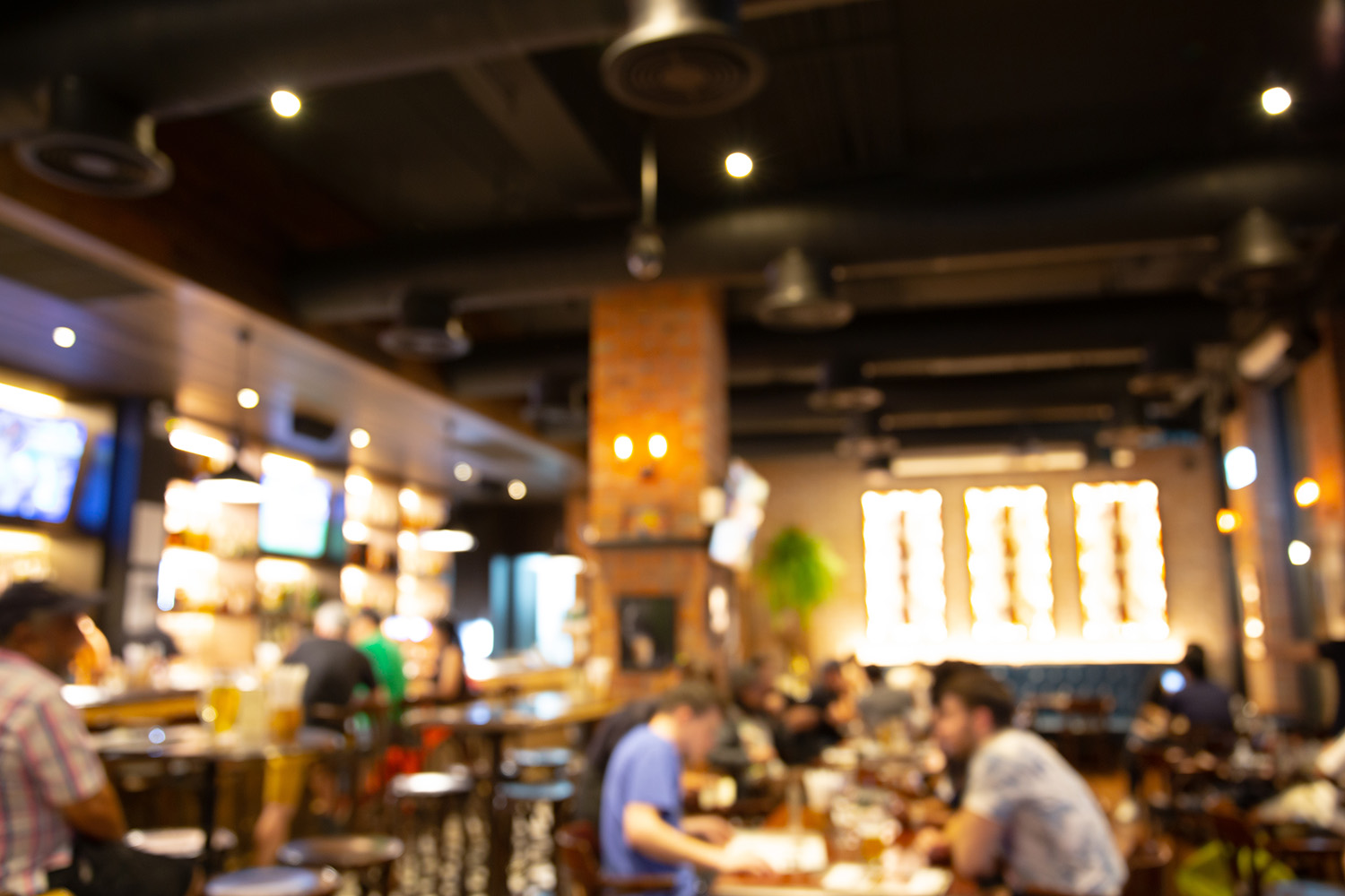 people talking in a busy restaurant with background noise affecting conversation clarity