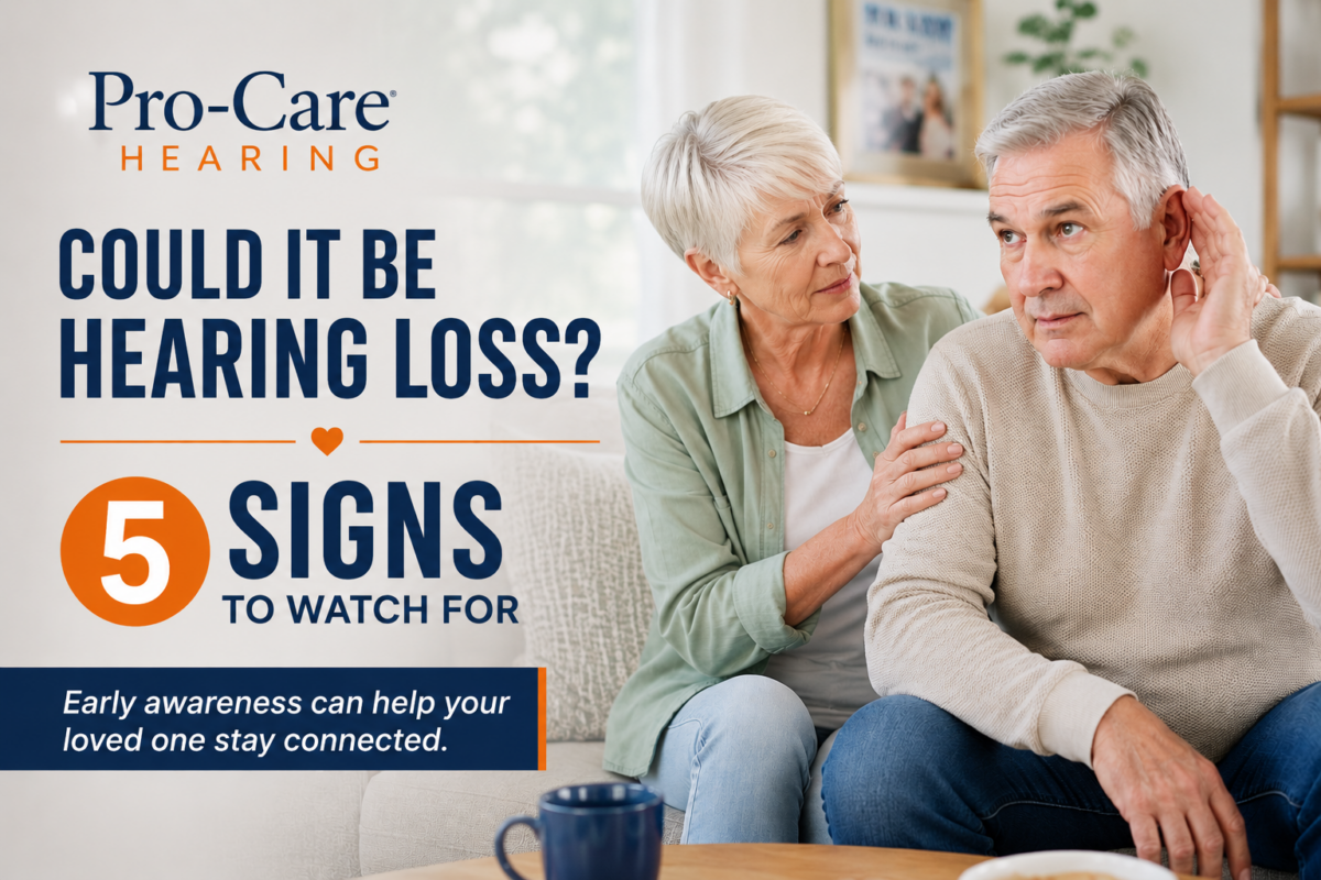 Older couple sitting together at home as a woman helps her husband who appears to be struggling to hear — hearing loss awareness from Pro-Care Hearing.