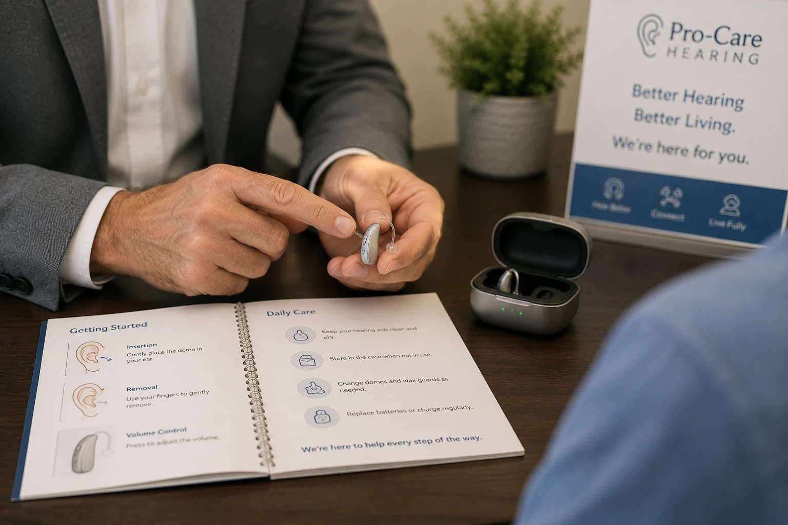 Hearing specialist demonstrating how to use and care for a hearing aid during a personalized fitting appointment at Pro-Care Hearing in Plattsburgh, NY.